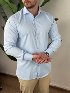 Svetloplava elegantna košulja na modelu, frontalni kadar uz svetle pantalone
